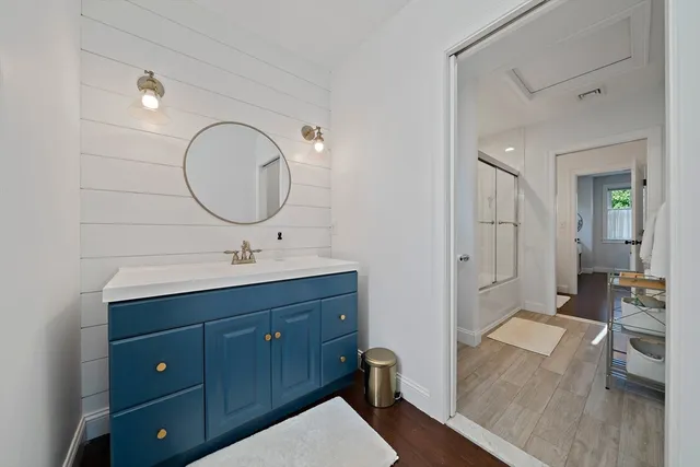 a bathroom with a toilet a sink a mirror and vanity