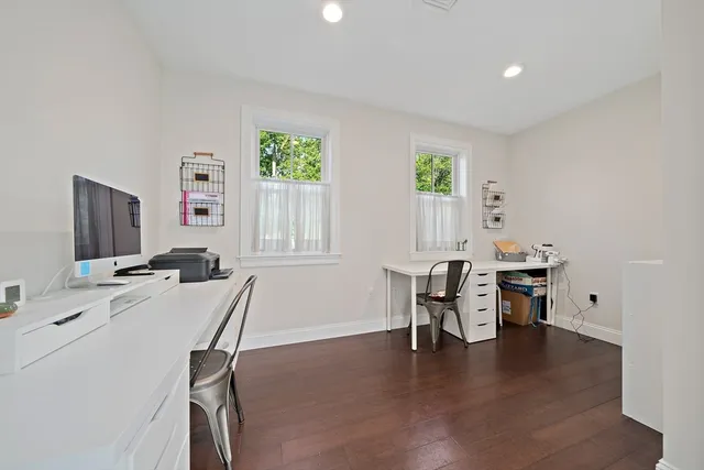 a workspace with furniture window and wooden floor
