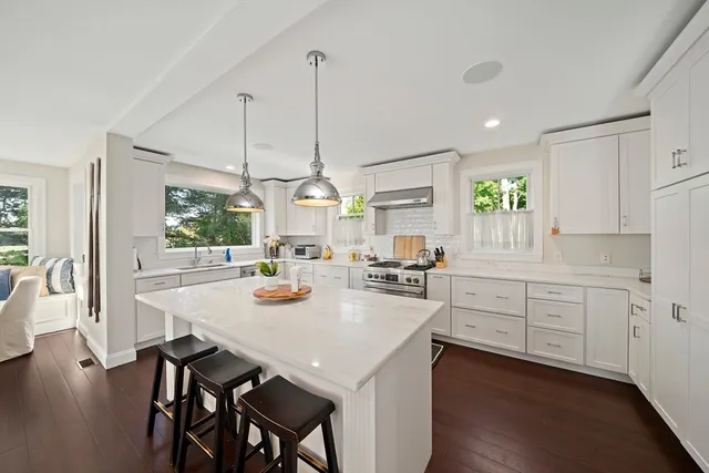 a kitchen with sink cabinets and wooden floor