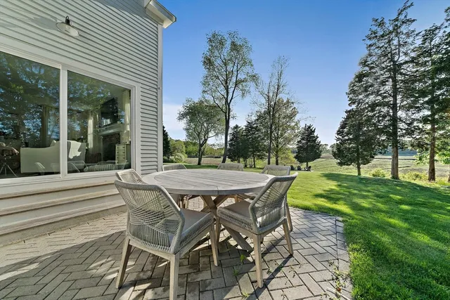 a view of a patio with table and chairs and potted plants