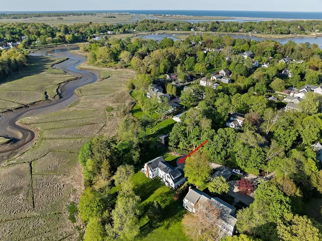 an aerial view of a houses with a yard