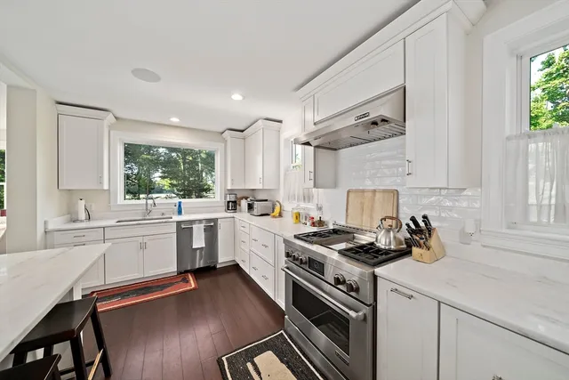 a kitchen with sink a stove and cabinets