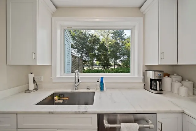 a kitchen with a sink and a large window