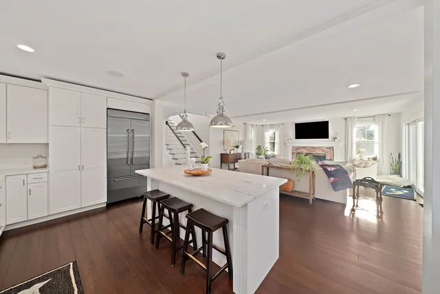 a large kitchen with a table and chairs