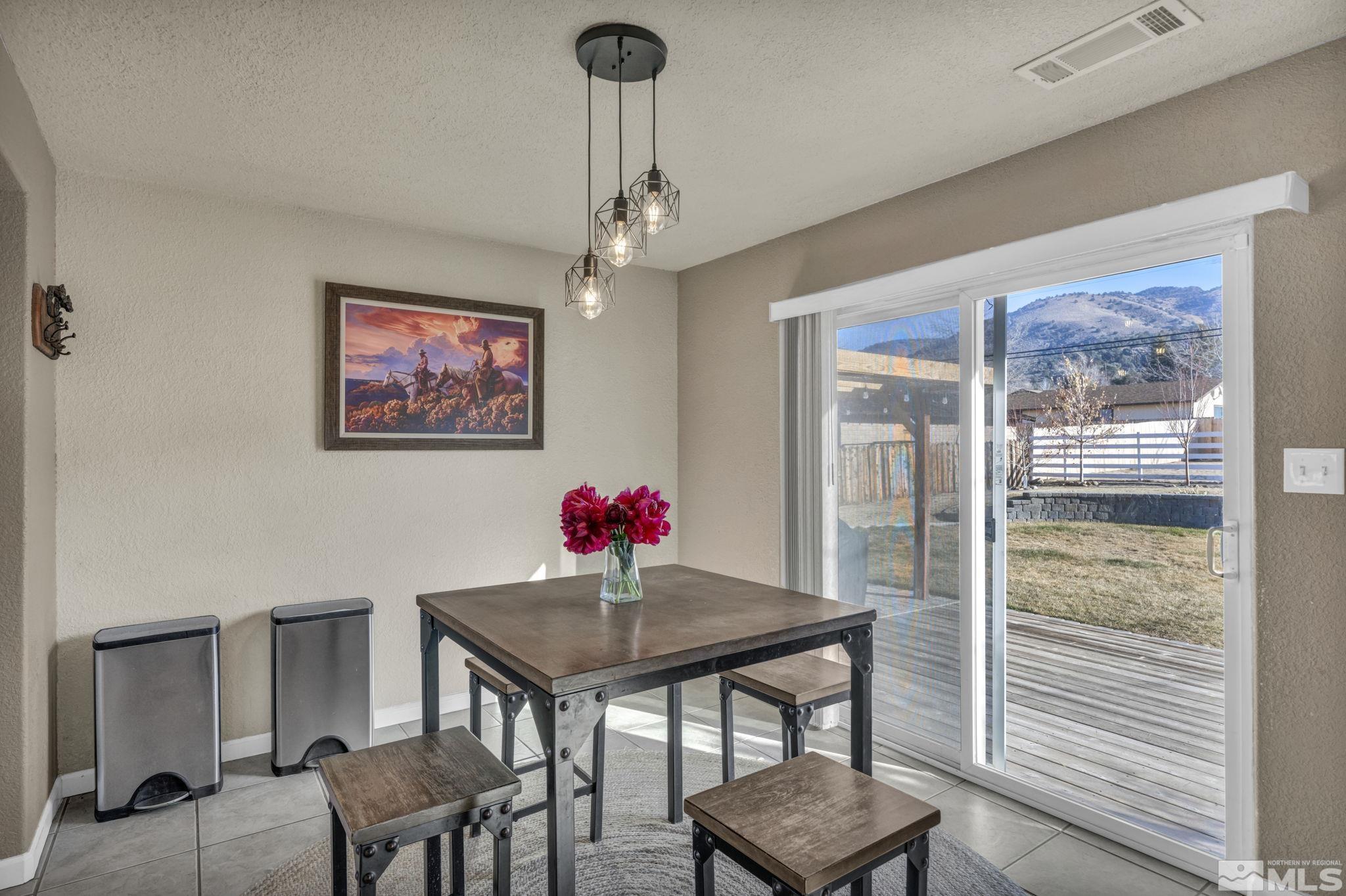 14660 Chamy Drive Reno, NV 89521 - Photo 15 of 38 a view of a dining room with furniture and wooden floor