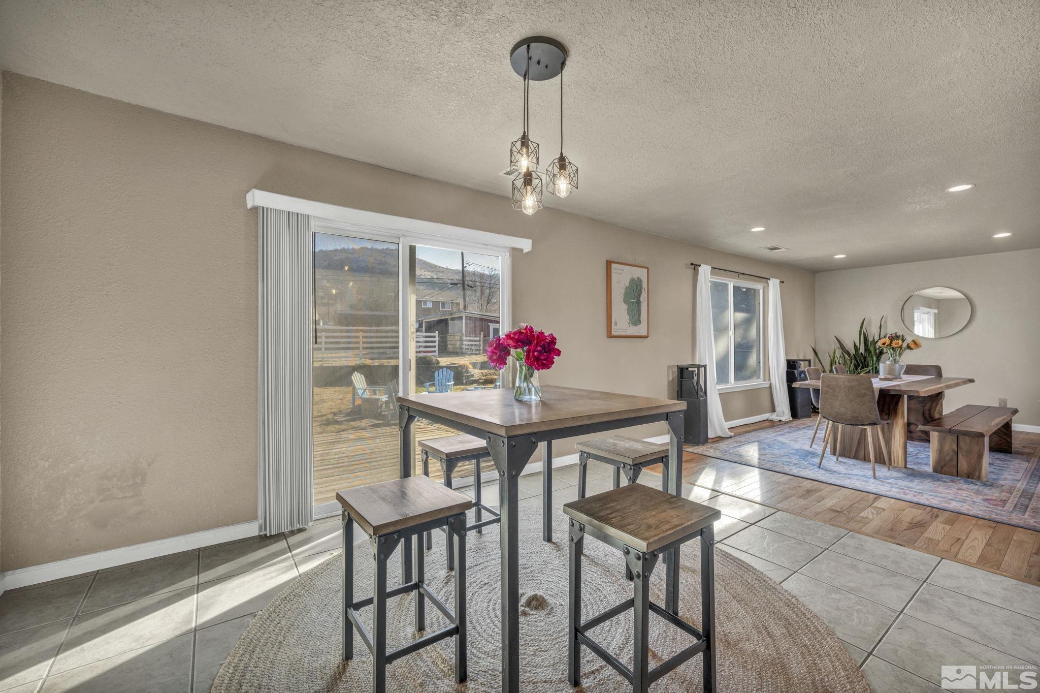 14660 Chamy Drive Reno, NV 89521 - Photo 16 of 38 a view of a dining room with furniture and a chandelier