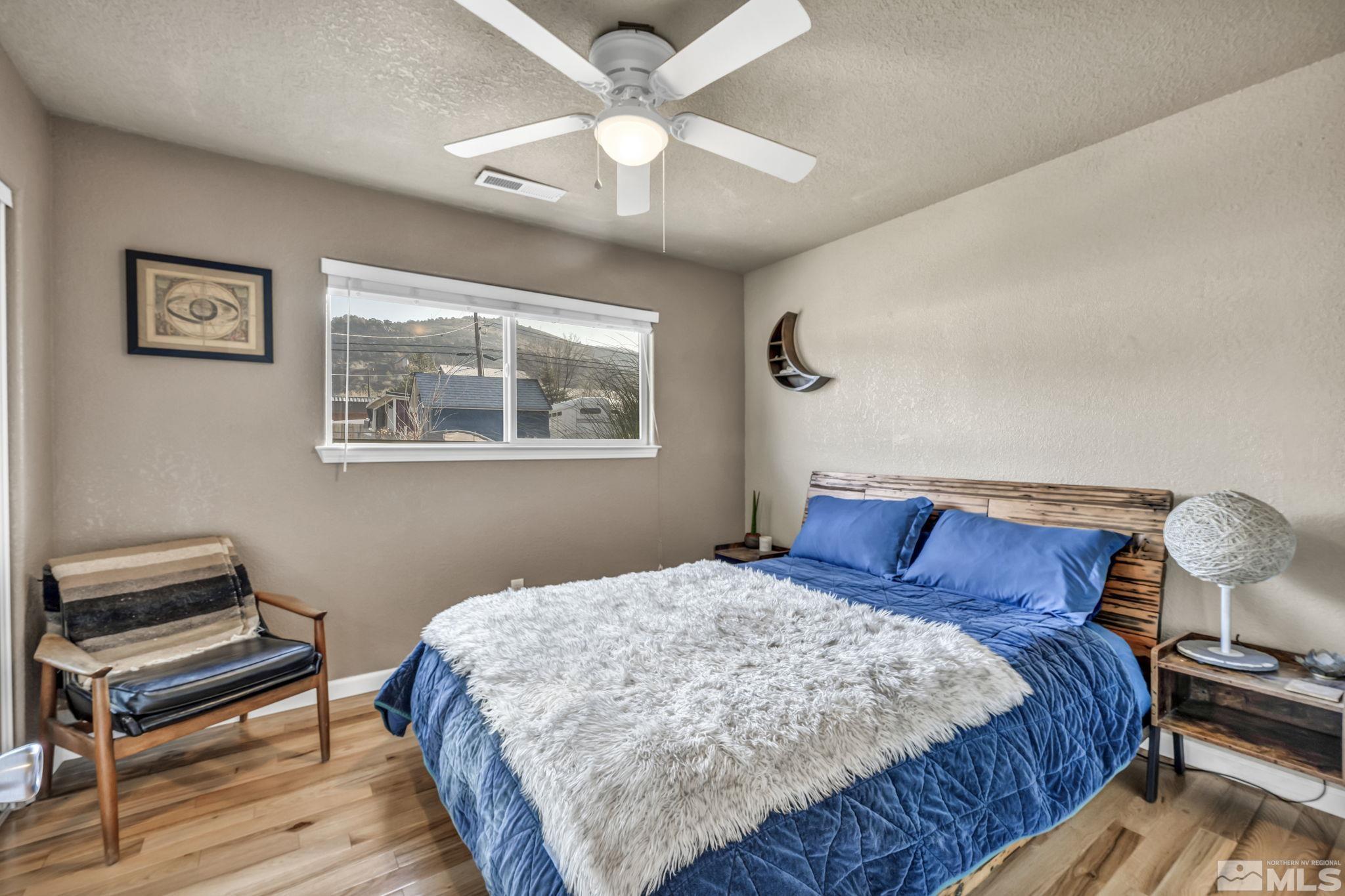 14660 Chamy Drive Reno, NV 89521 - Photo 28 of 38 a bedroom with a bed and a chandelier