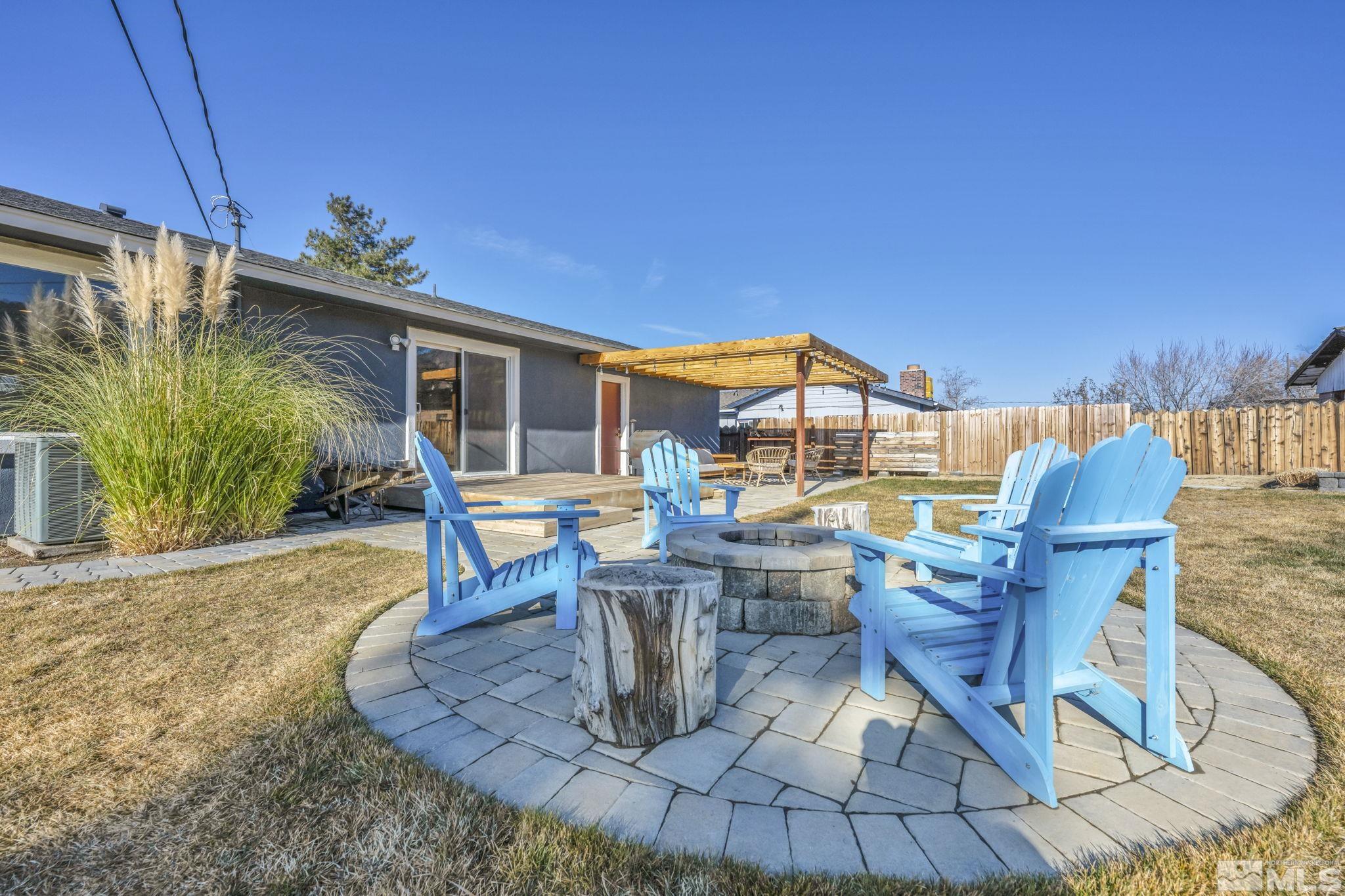 14660 Chamy Drive Reno, NV 89521 - Photo 31 of 38 a view of a patio with table and chairs potted plants with wooden fence