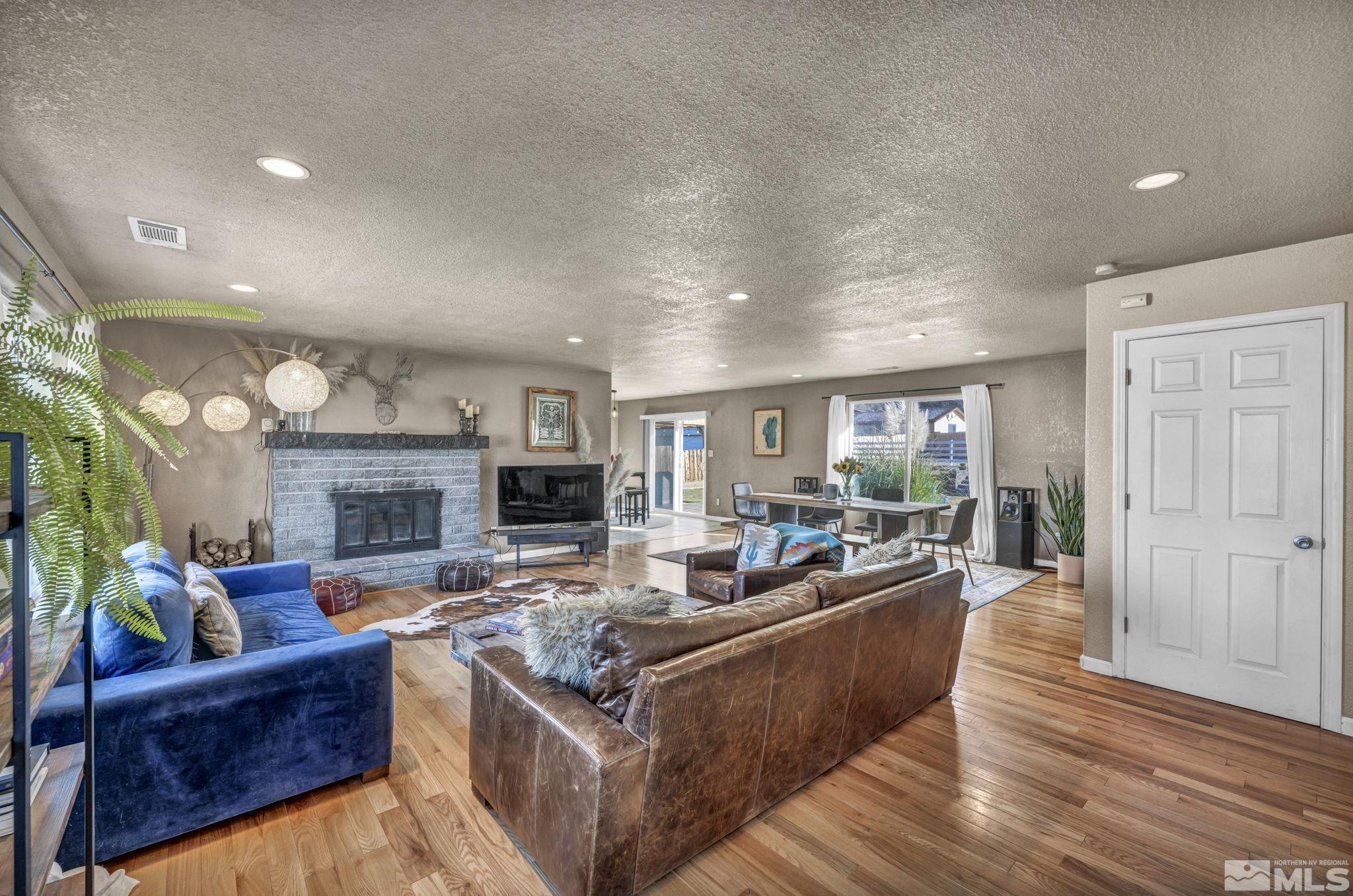 14660 Chamy Drive Reno, NV 89521 - Photo 6 of 38 a living room with fireplace furniture and a fireplace