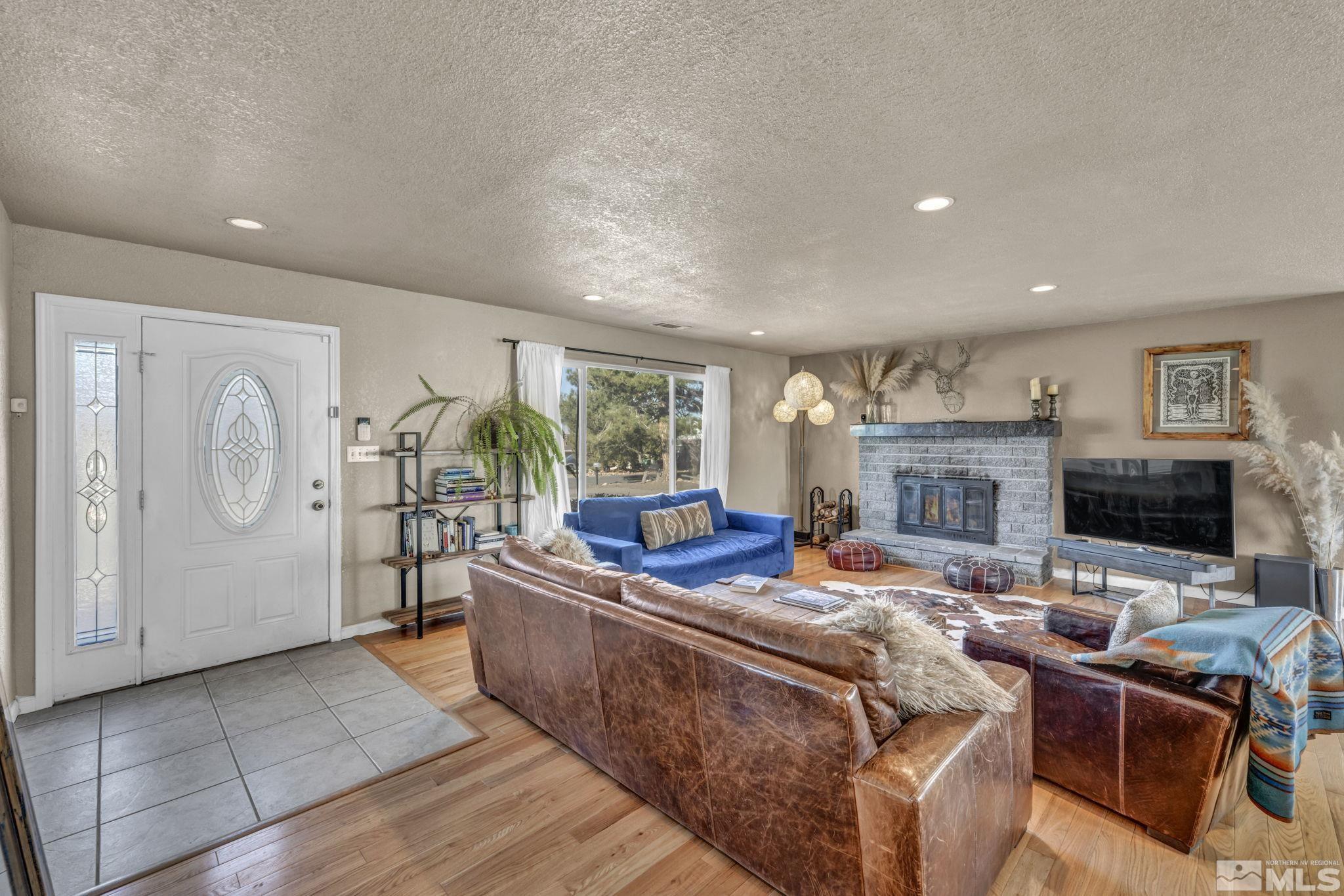 14660 Chamy Drive Reno, NV 89521 - Photo 7 of 38 a living room with fireplace furniture and a flat screen tv