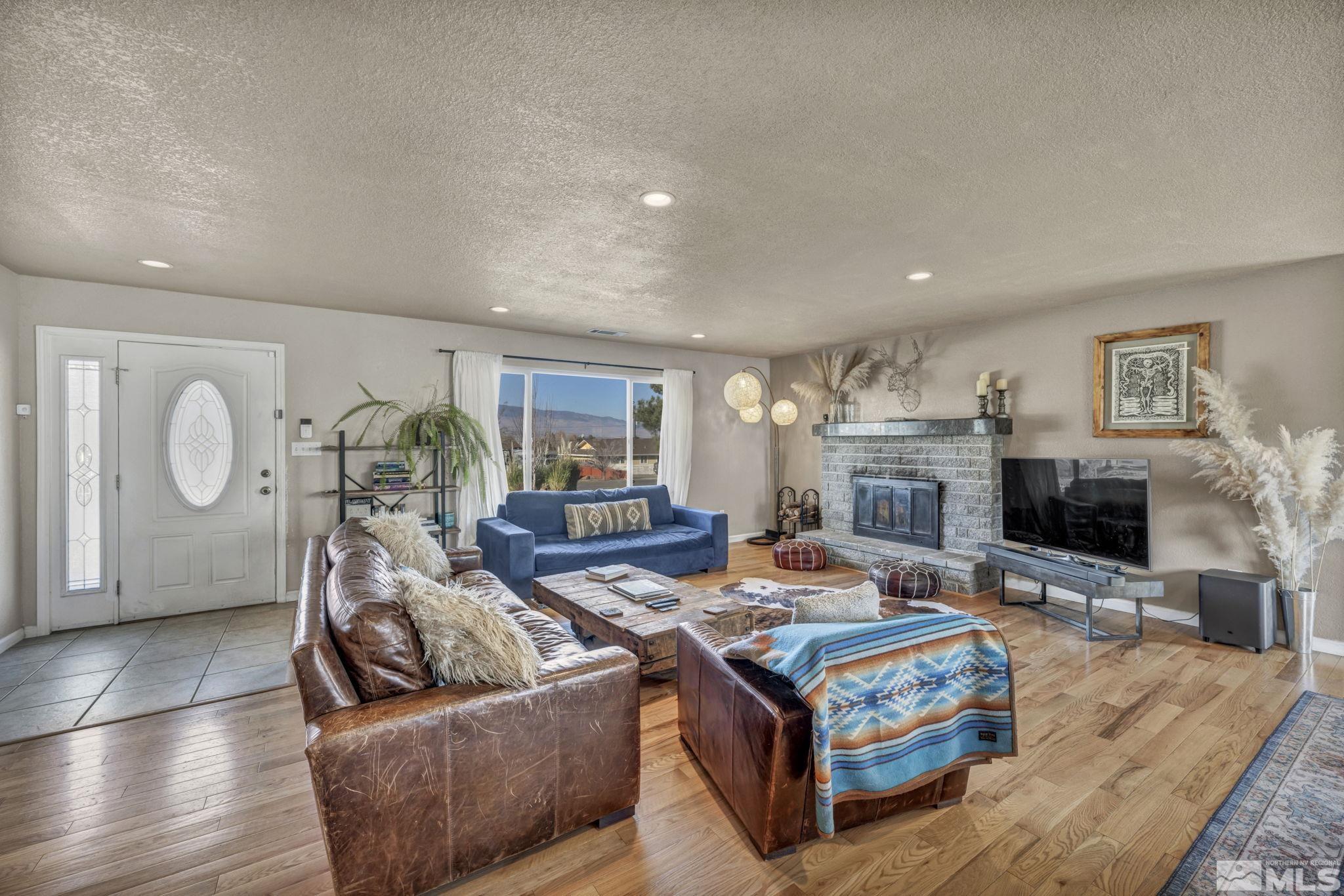 14660 Chamy Drive Reno, NV 89521 - Photo 8 of 38 a living room with fireplace furniture and a flat screen tv