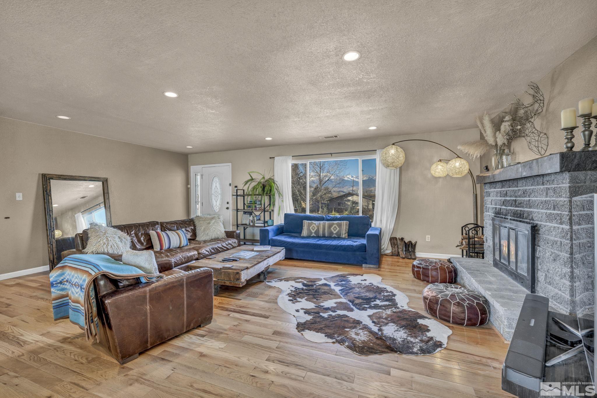 14660 Chamy Drive Reno, NV 89521 - Photo 9 of 38 a living room with furniture wooden floor and a fireplace