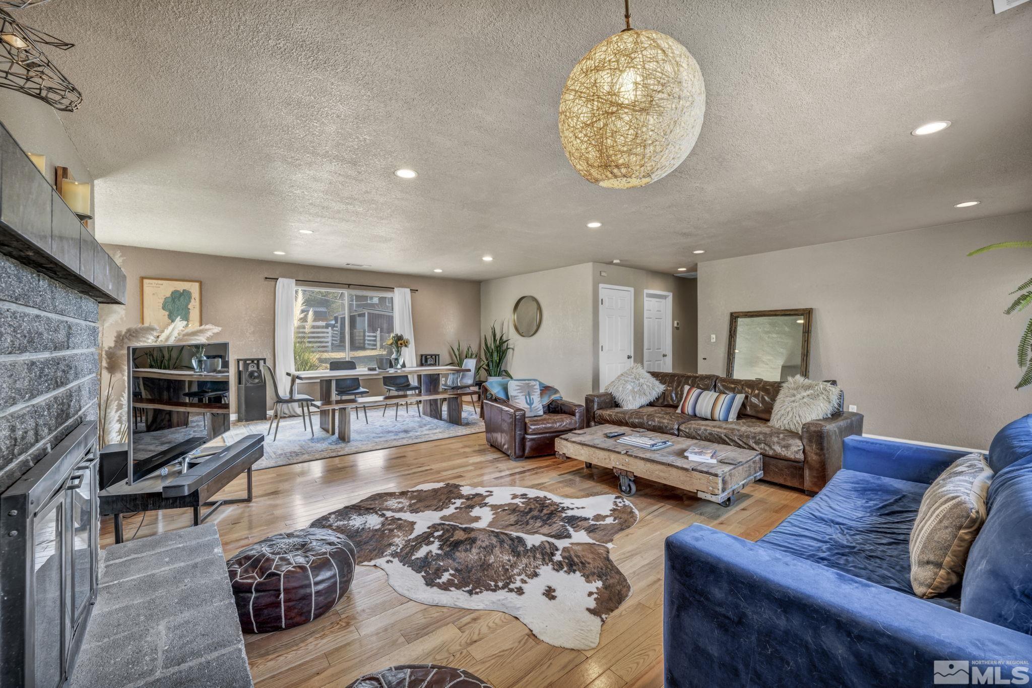14660 Chamy Drive Reno, NV 89521 - Photo 10 of 38 a living room with furniture a fireplace and a flat screen tv