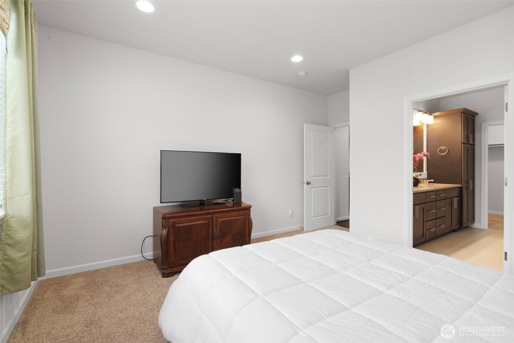 3311 Colville Street Southeast Lacey, WA 98513 - Photo 11 of 40 a bedroom with a bed and a flat screen tv