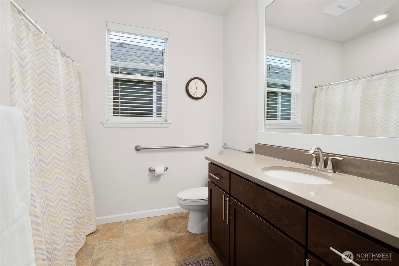 3311 Colville Street Southeast Lacey, WA 98513 - Photo 16 of 40 a bathroom with a sink a toilet a mirror and a window