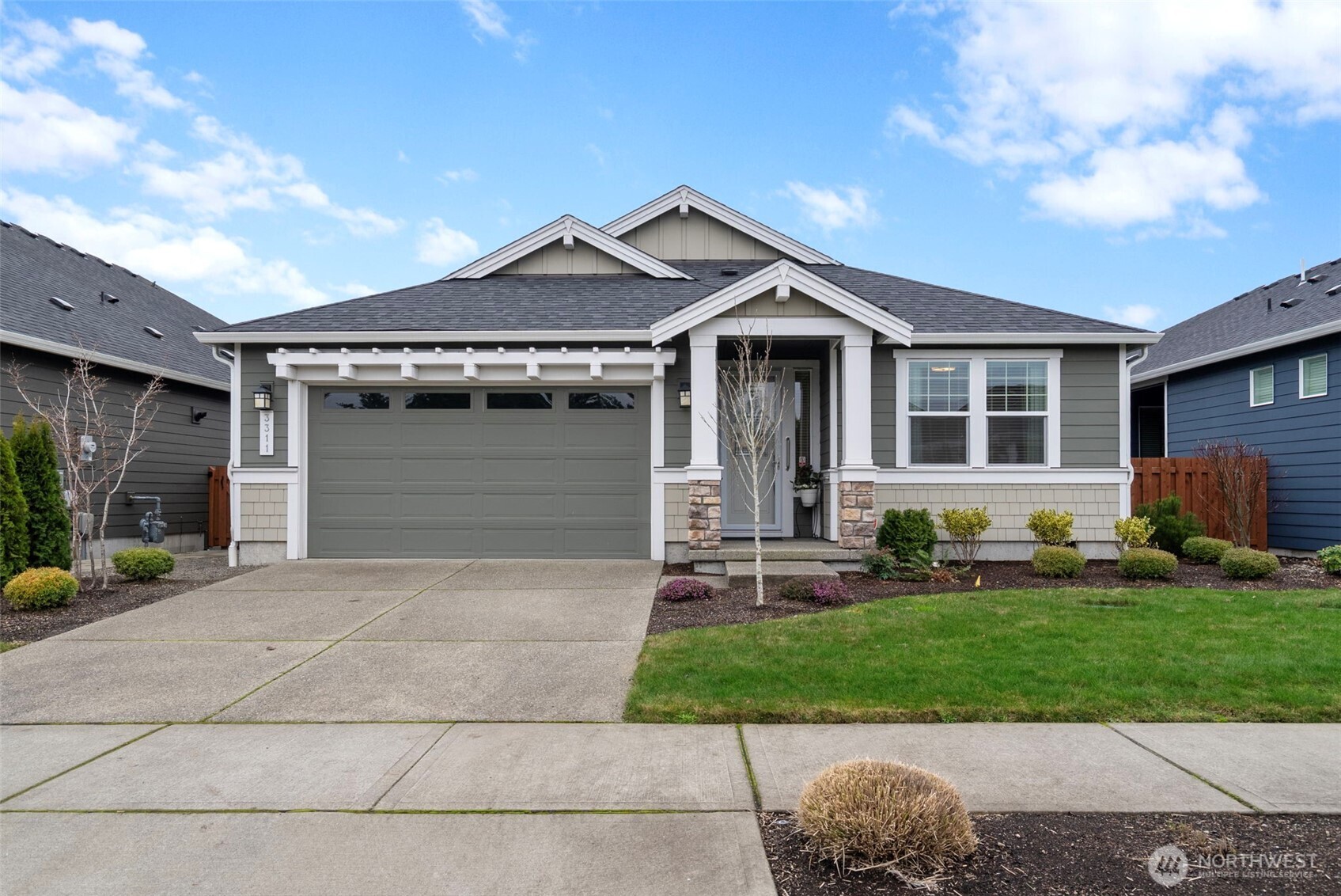 3311 Colville Street Southeast Lacey, WA 98513 - Photo 39 of 40 a front view of a house with a yard and garage
