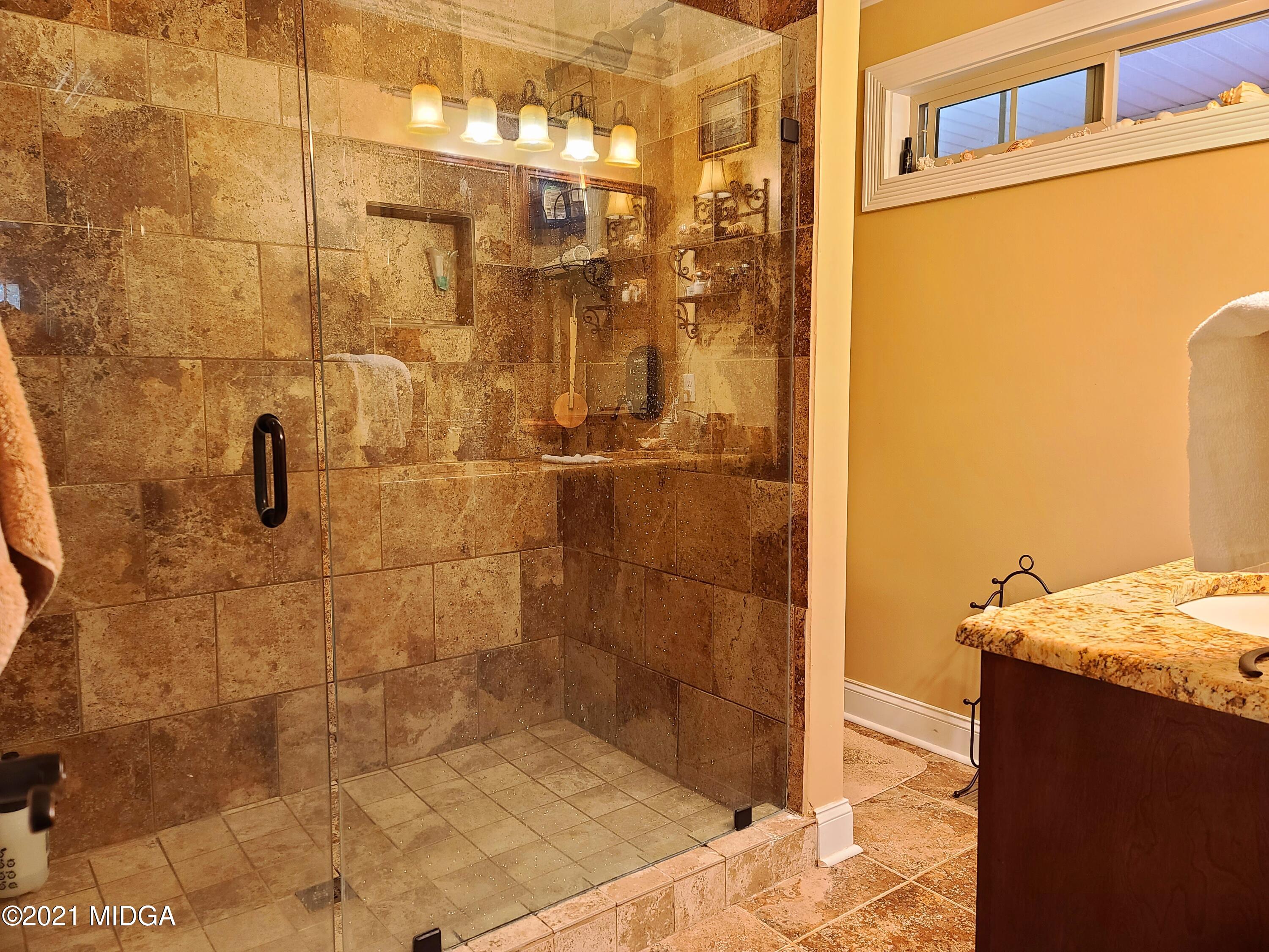 464 Loblolly Lane Macon, GA 31220 - Photo 20 of 48 a bathroom with a granite countertop shower and a sink