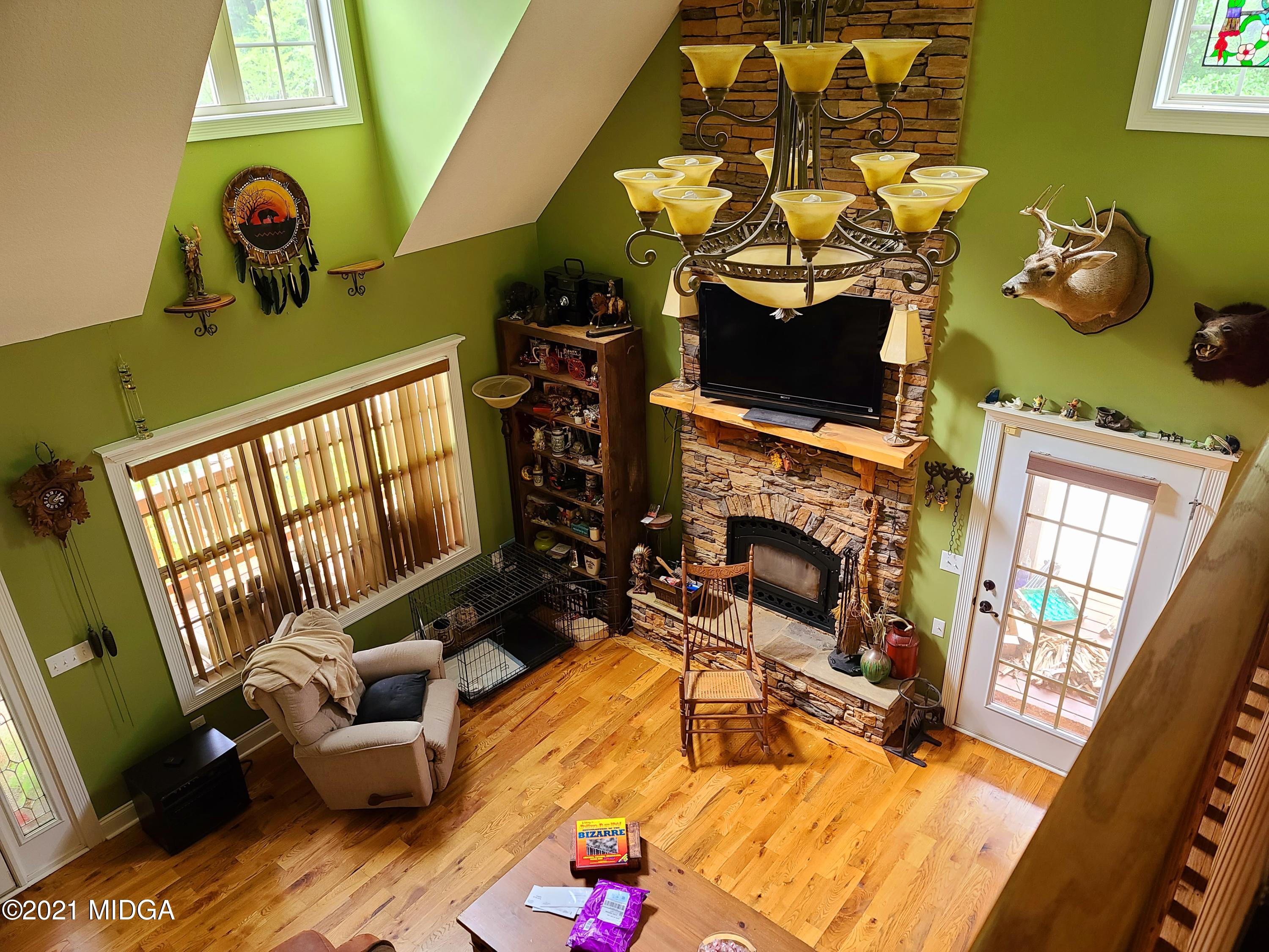 464 Loblolly Lane Macon, GA 31220 - Photo 26 of 48 a living room with furniture a fireplace and a floor to ceiling window