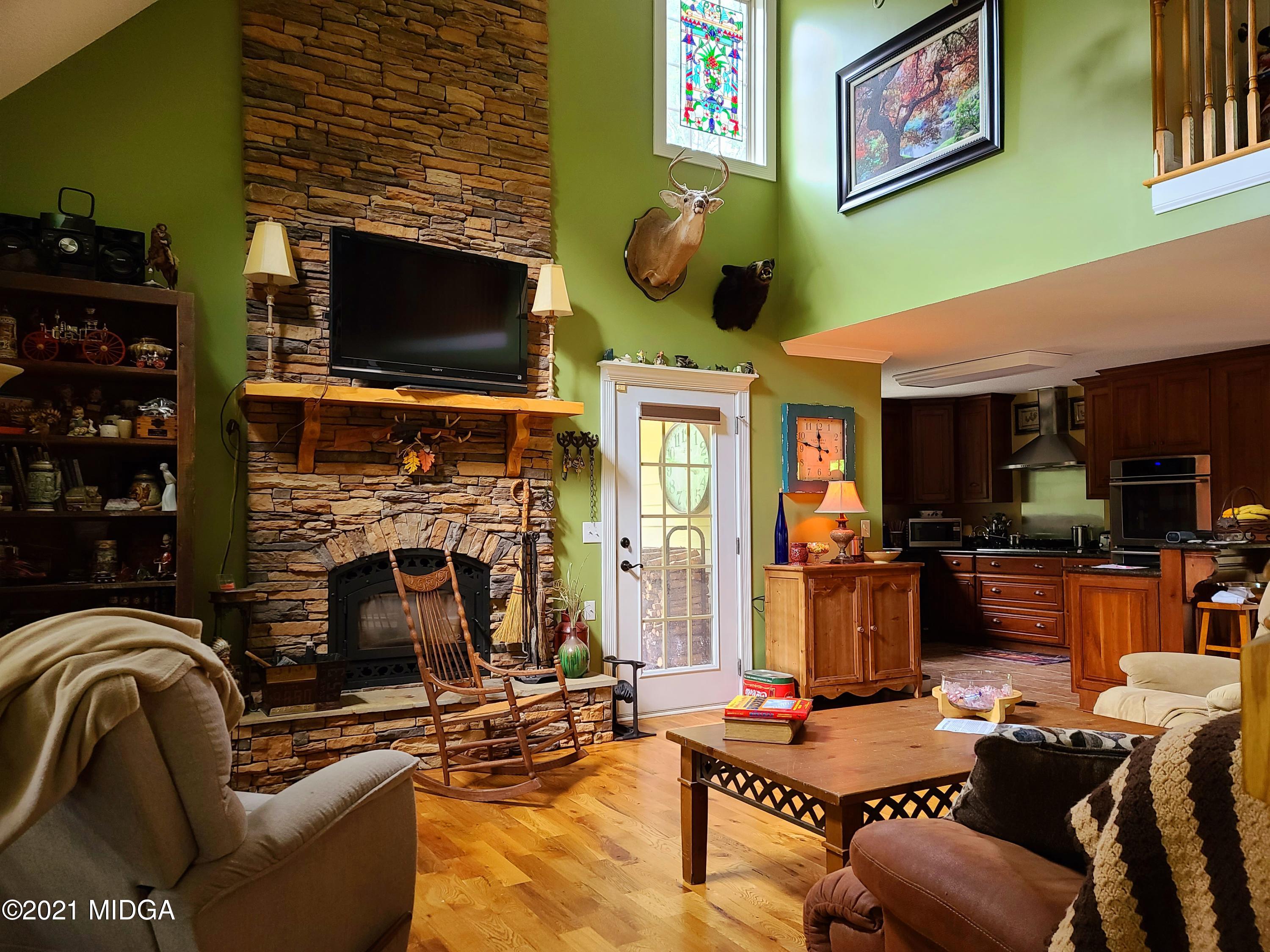 464 Loblolly Lane Macon, GA 31220 - Photo 28 of 48 a living room with furniture a flat screen tv and a fireplace