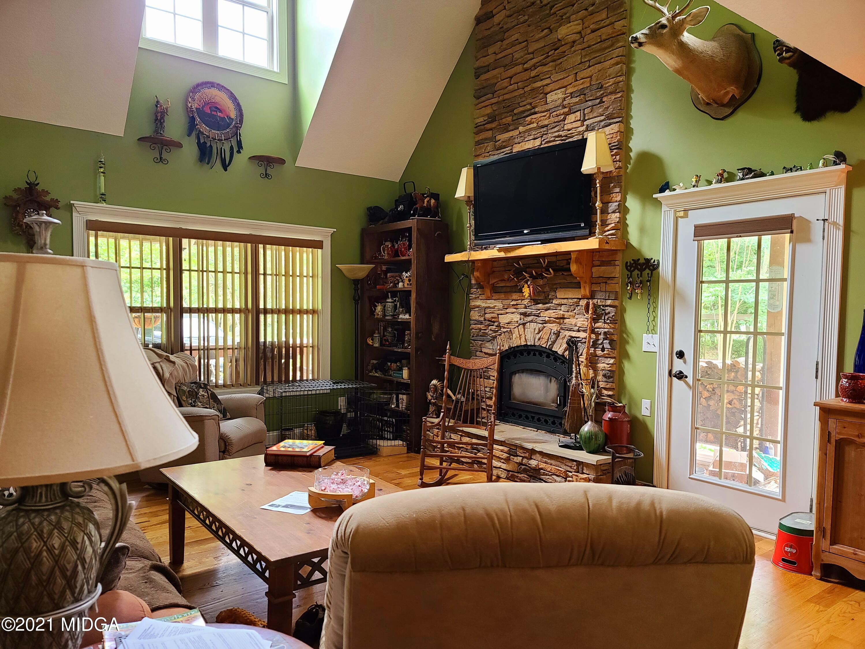 464 Loblolly Lane Macon, GA 31220 - Photo 29 of 48 a living room with furniture a flat screen tv and a fireplace