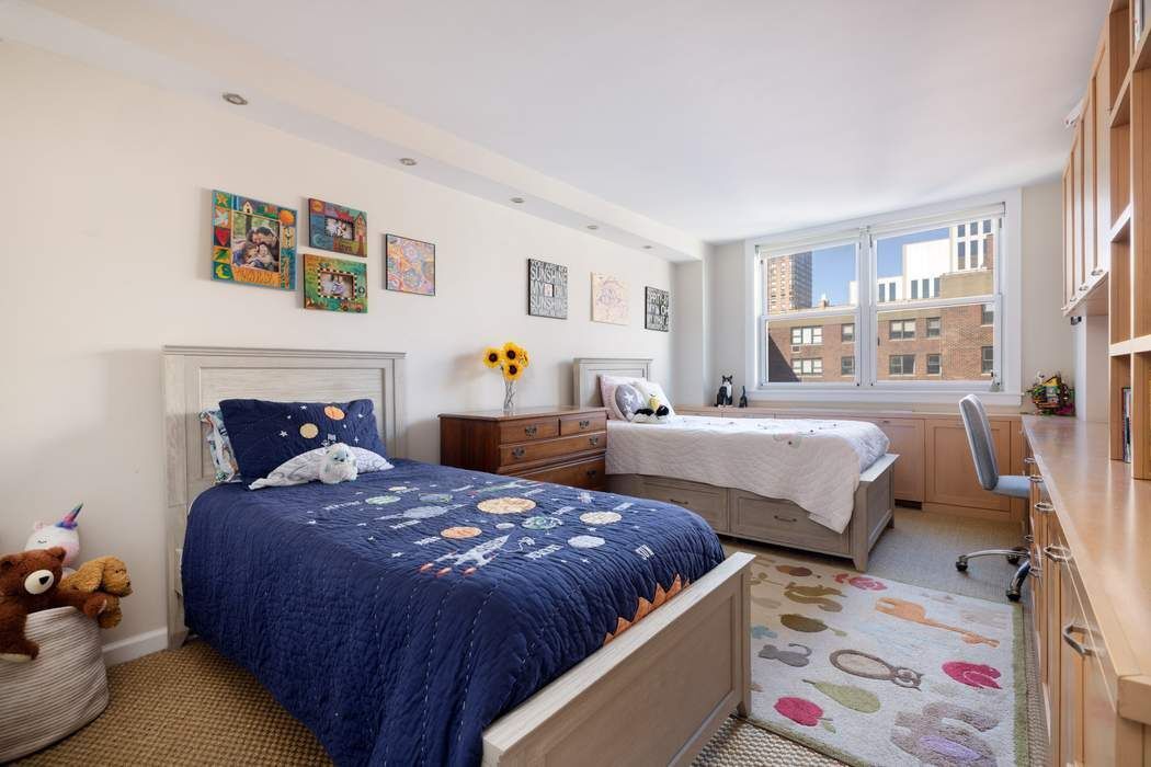 501 East 79th Street, Unit 14E Manhattan, NY 10075 - Photo 11 of 19 a bedroom with a bed and wooden floor