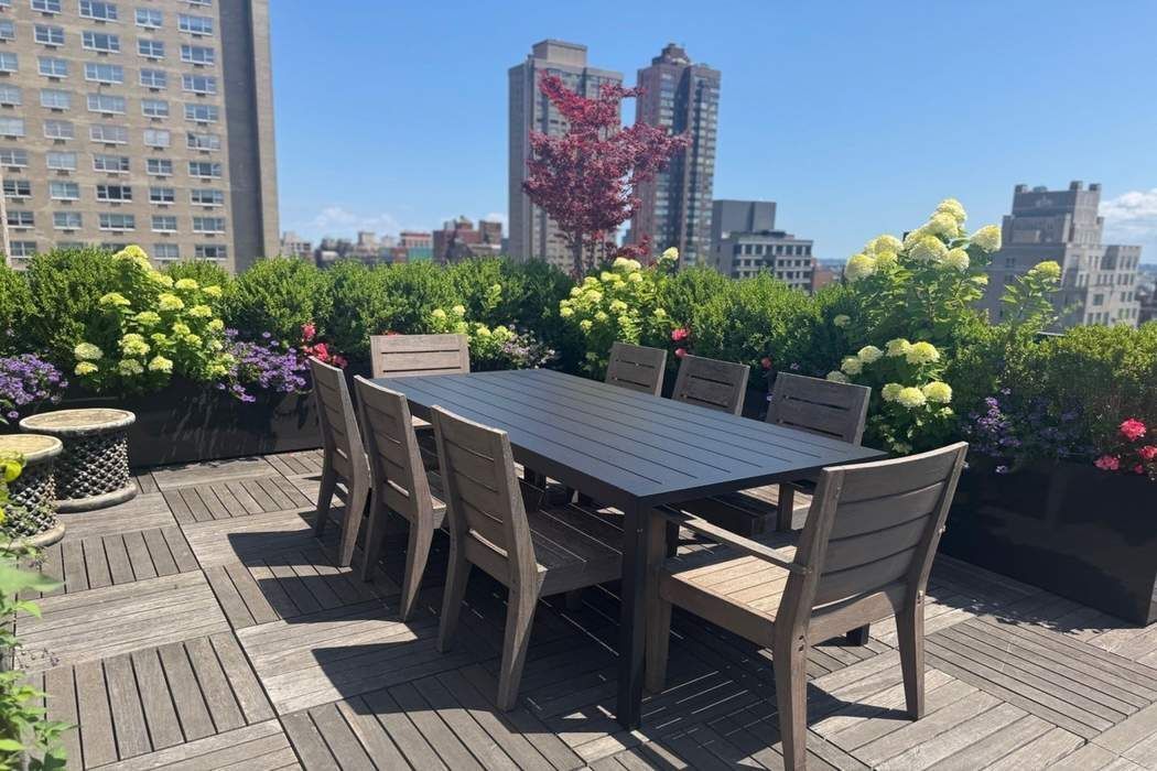 501 East 79th Street, Unit 14E Manhattan, NY 10075 - Photo 17 of 19 a view of a roof deck with table and chairs and potted plants