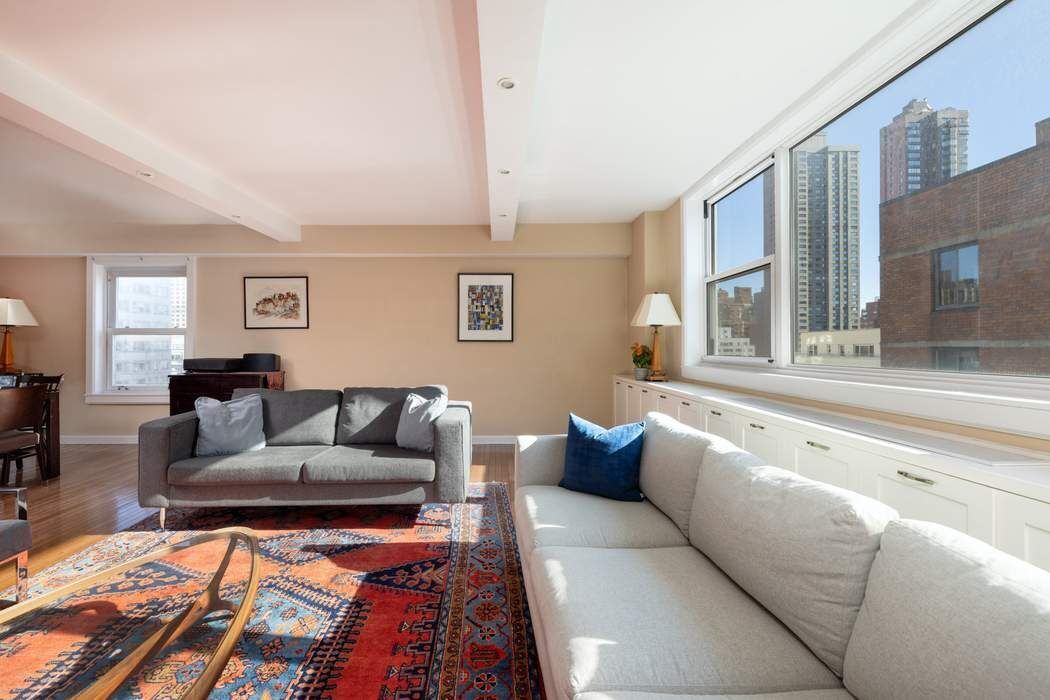 501 East 79th Street, Unit 14E Manhattan, NY 10075 - Photo 2 of 19 a living room with furniture and a large window