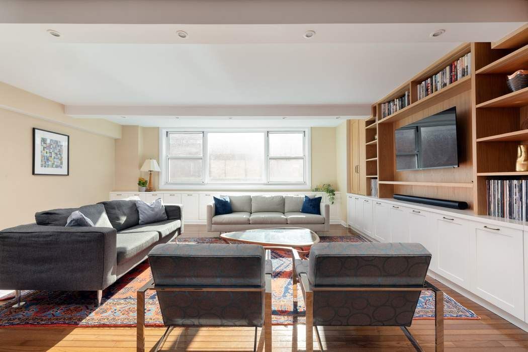 501 East 79th Street, Unit 14E Manhattan, NY 10075 - Photo 5 of 19 a living room with furniture and a flat screen tv