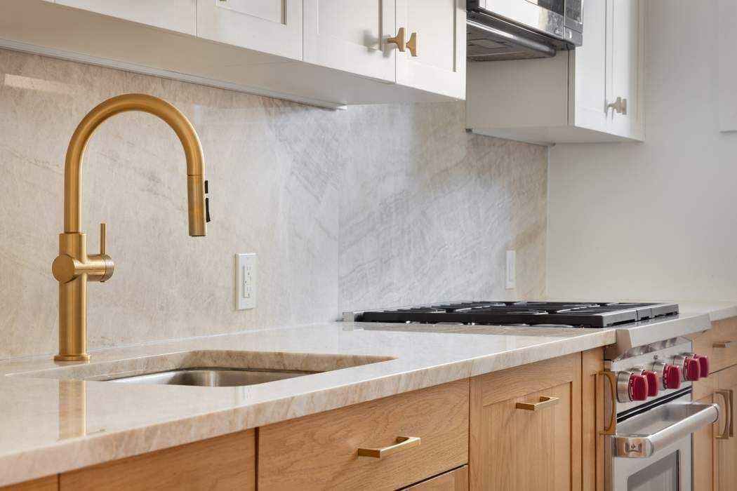 501 East 79th Street, Unit 14E Manhattan, NY 10075 - Photo 8 of 19 a kitchen with granite countertop a sink and cabinets