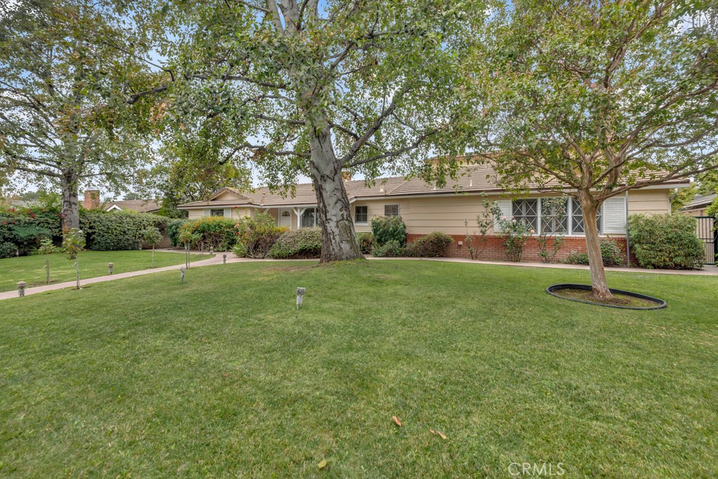 a view of house with backyard