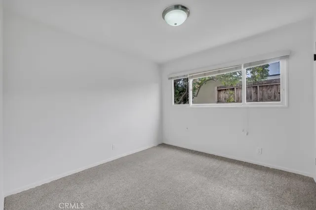 a bathroom with a granite countertop sink a mirror and a bathtub