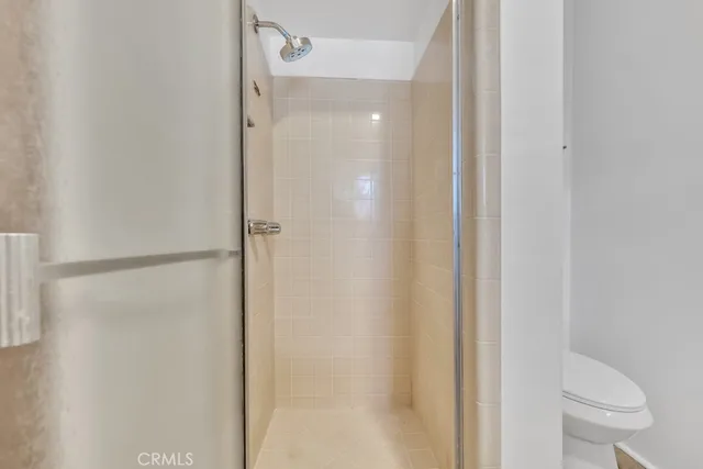 a large white kitchen with granite countertop a sink white cabinets and white stainless steel appliances