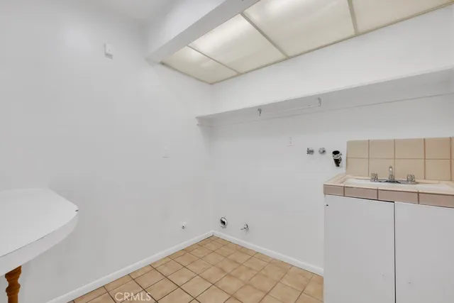 a view of an empty room with a fireplace and a window