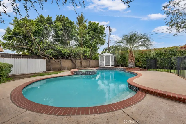 a view of a house with swimming pool and a porch