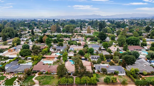 an aerial view of a house with an outdoor space and street view