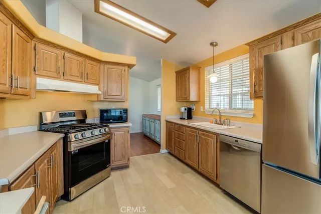 a kitchen with stainless steel appliances granite countertop a stove and a refrigerator