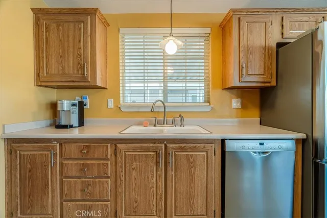 a kitchen with stainless steel appliances granite countertop a sink and a window