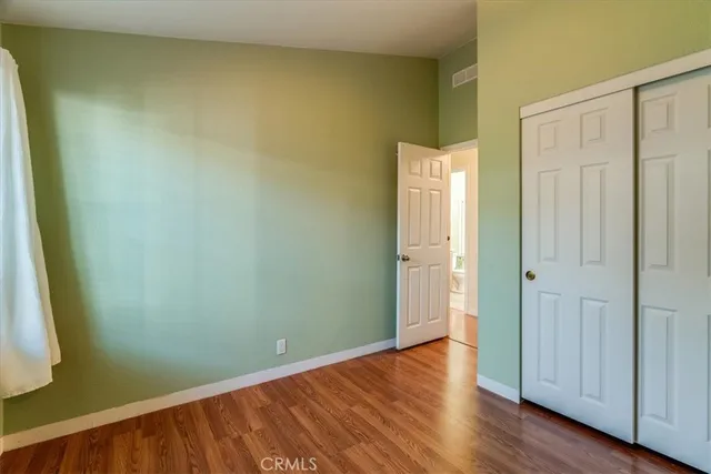 a view of an empty room and wooden floor