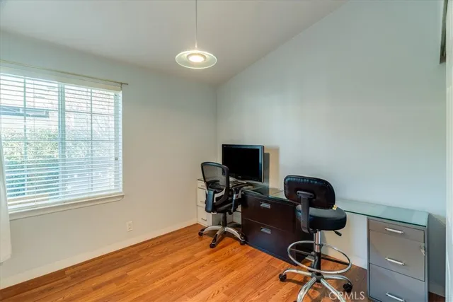 a view of a workspace with furniture and a window