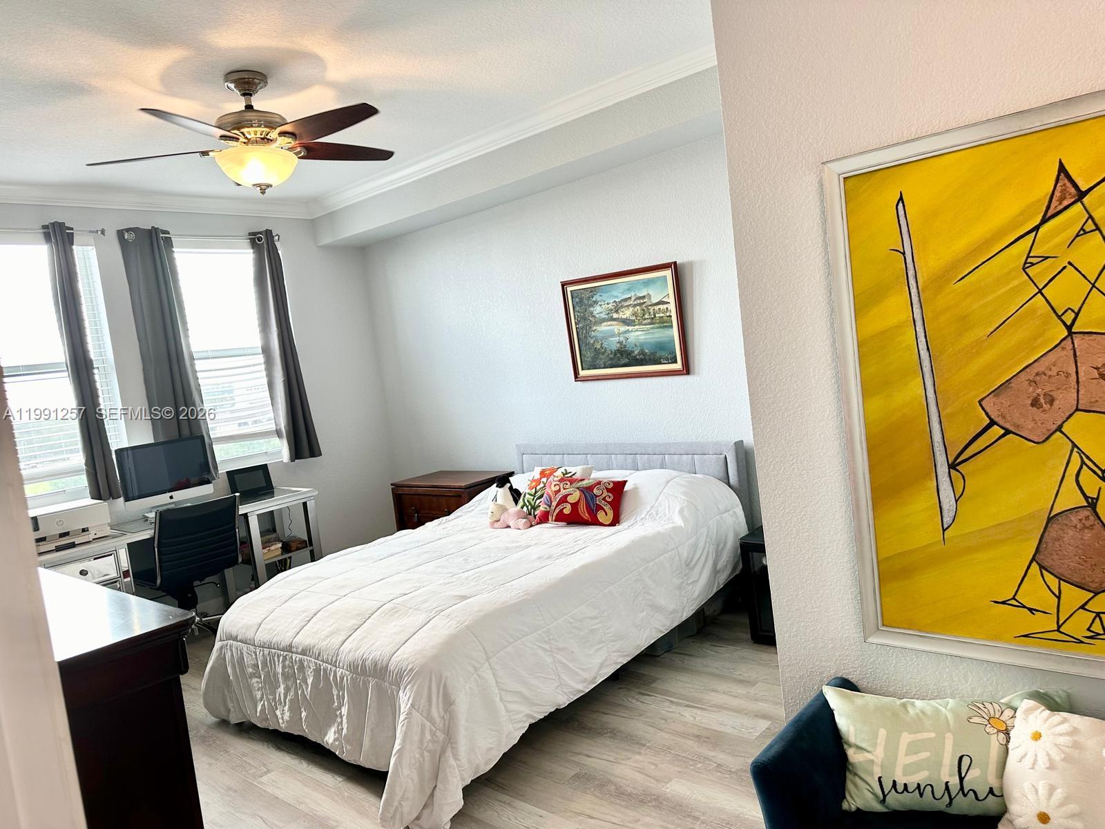 1660 Renaissance Commons Boulevard, Unit 2606 Boynton Beach, FL 33426 - Photo 19 of 26 a bedroom with a bed and a window