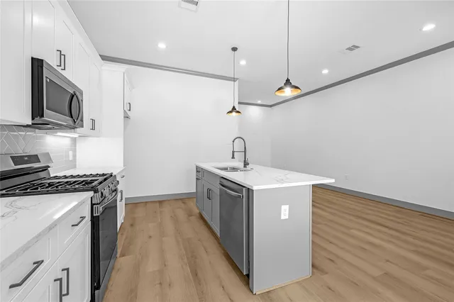 a kitchen with a stove and a microwave