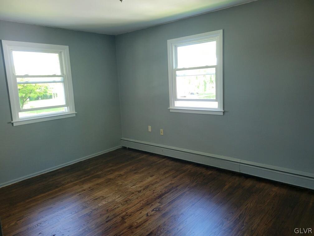 1413 Exeter Road Allentown, PA 18103 - Photo 5 of 16 an empty room with wooden floor and windows