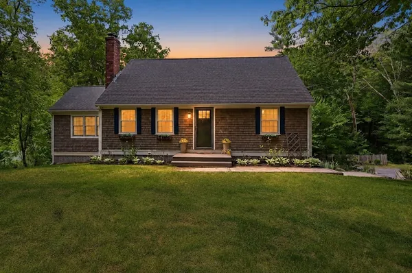 a front view of house with yard and outdoor seating