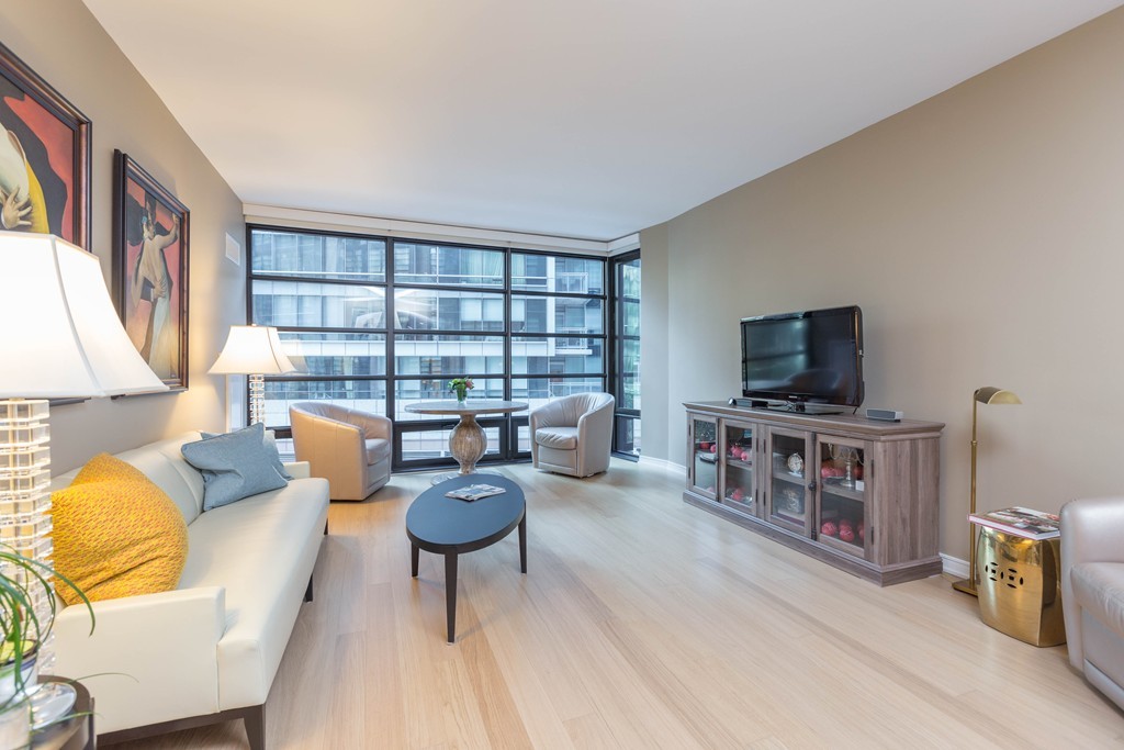 580 Washington Street, Unit 3F Boston, MA 02111 - Photo 2 of 24 a living room with furniture and a flat screen tv