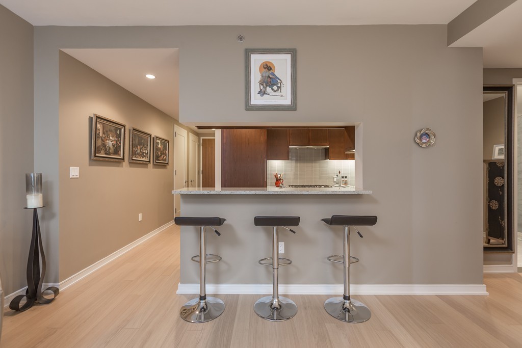 580 Washington Street, Unit 3F Boston, MA 02111 - Photo 7 of 24 a room with table chairs and a painting on the wall