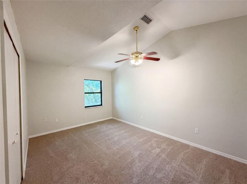 3739 Lake Griffin Road Lady Lake, FL 32159 - Photo 15 of 21 an empty room with a window and a chandelier fan