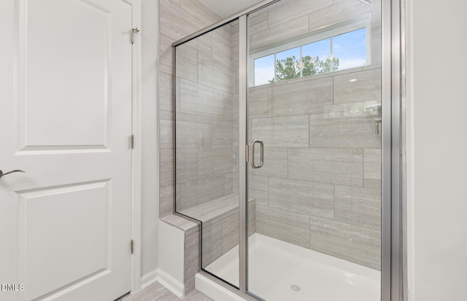 637 Fosterton Cottage Way Raleigh, NC 27603 - Photo 12 of 31 a bathroom with a glass shower door