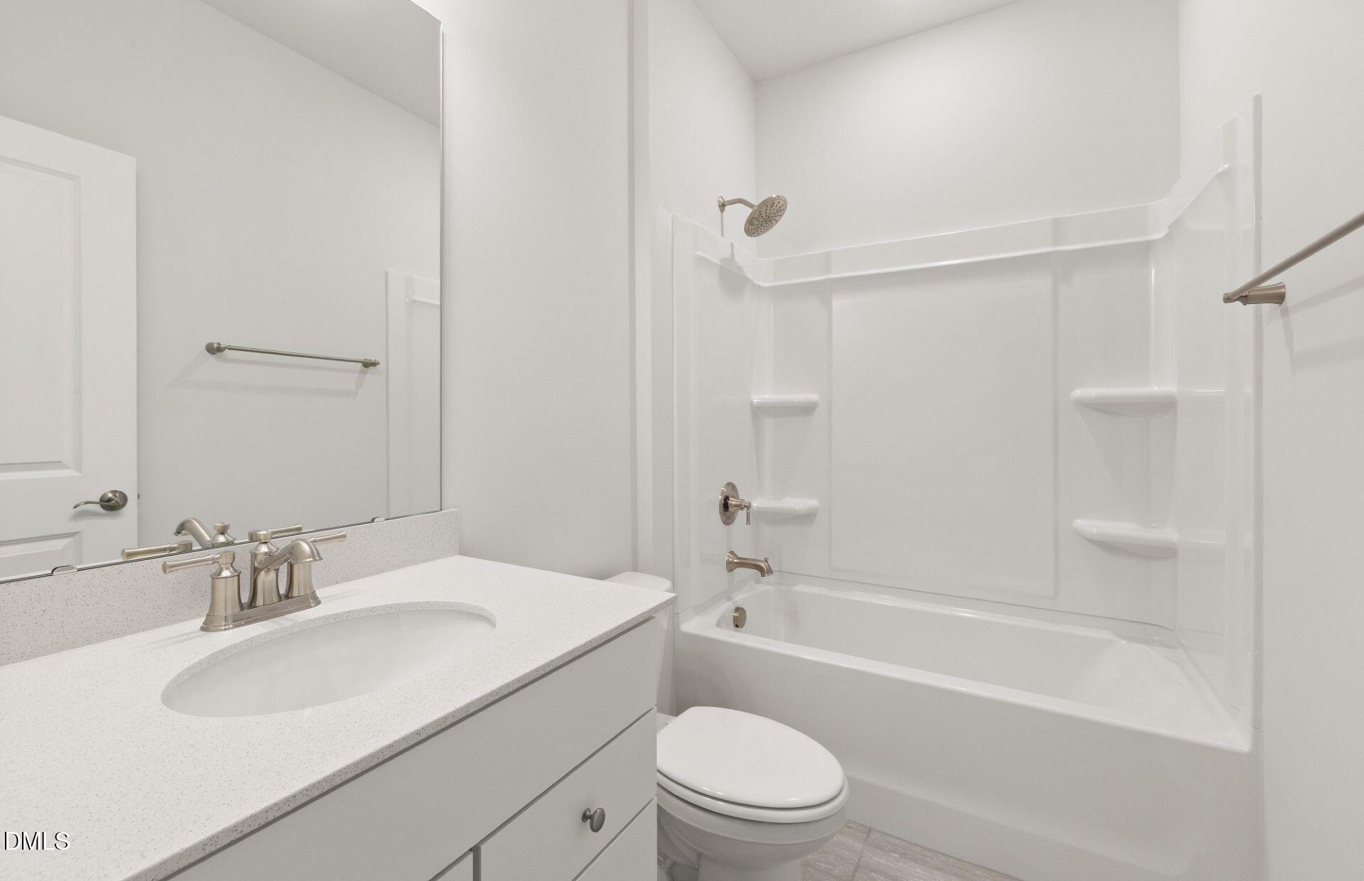 637 Fosterton Cottage Way Raleigh, NC 27603 - Photo 18 of 31 a bathroom with a sink toilet vanity and shower
