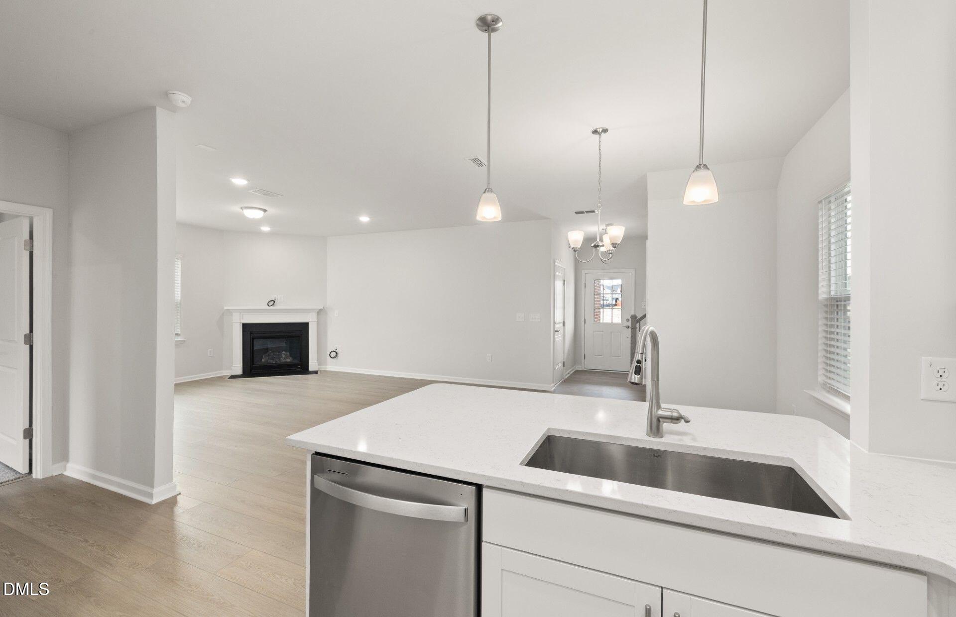 637 Fosterton Cottage Way Raleigh, NC 27603 - Photo 4 of 31 a kitchen with a sink and a ceiling fan