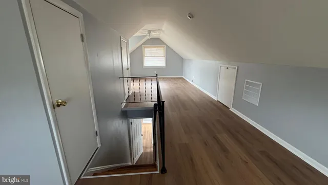 a view of a livingroom with wooden floor and staircase